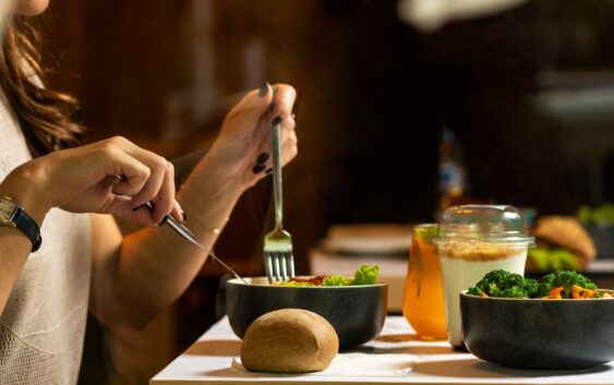 person holding silver fork and knife